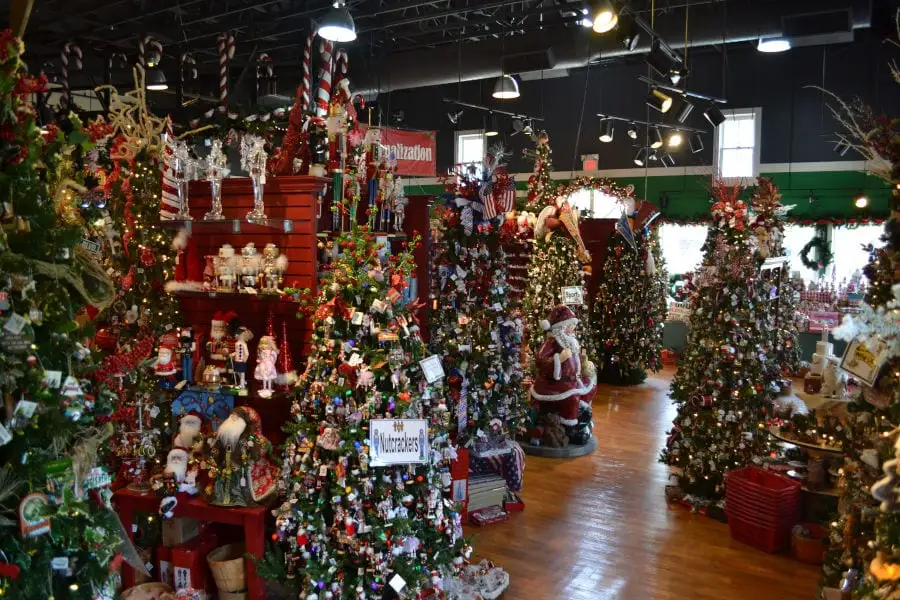 interior of Kringles Christmas Shop with various ornaments, decor and Christmas trees on display