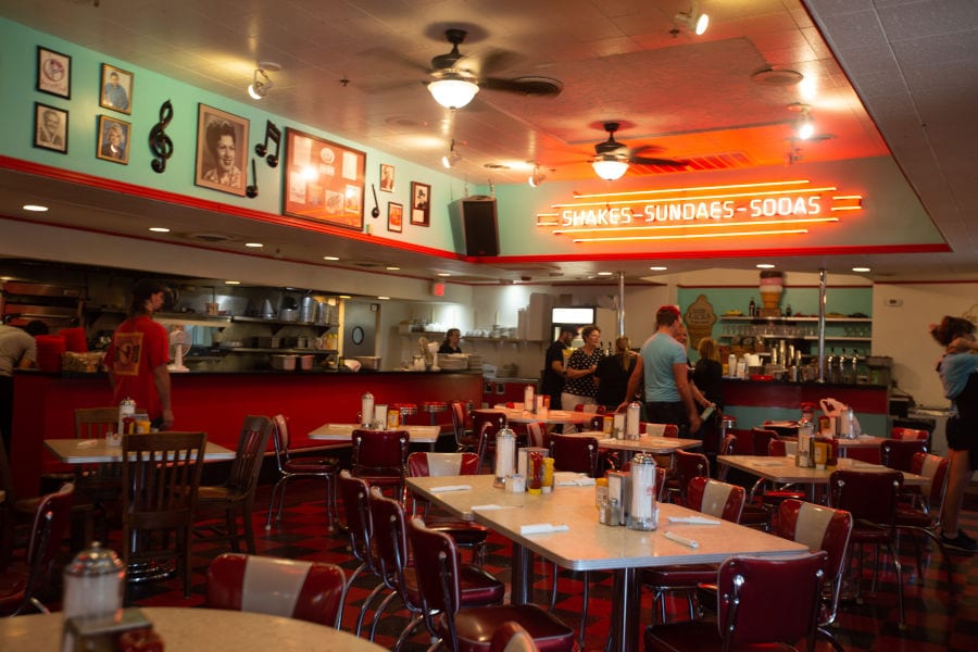 interior of Mel's Diner with neon signs on the walls and classic seating for guests