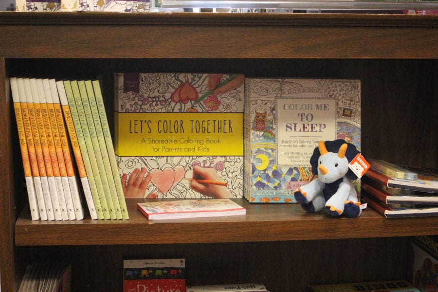 coloring books and a plush triceratops at T Charleston Books and Gifts