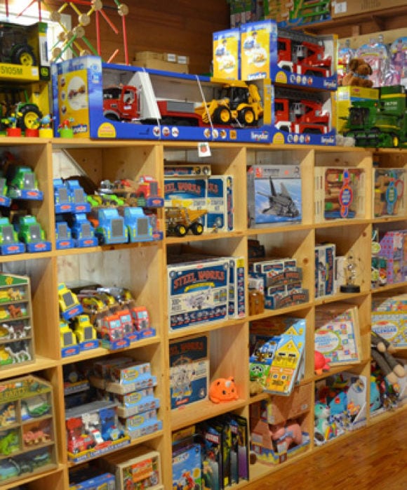 rows of toy trucks, puzzles, and board games at Back in Time Toys