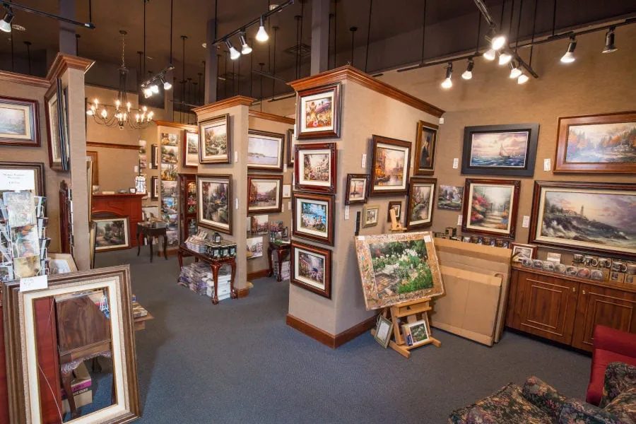 interior of Reflections Gallery with rows and rows of paintings on the wall