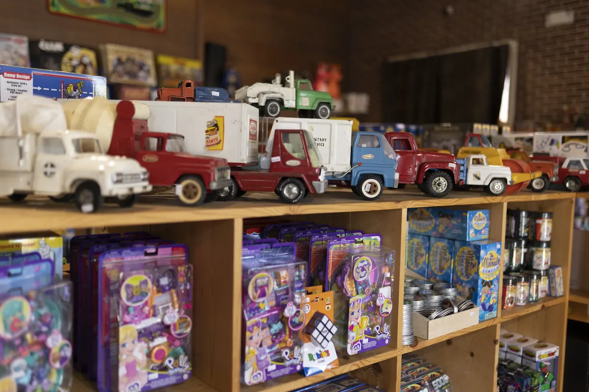 Children's toy trucks and trinkets displayed on shelves at Back in Time Toy shop